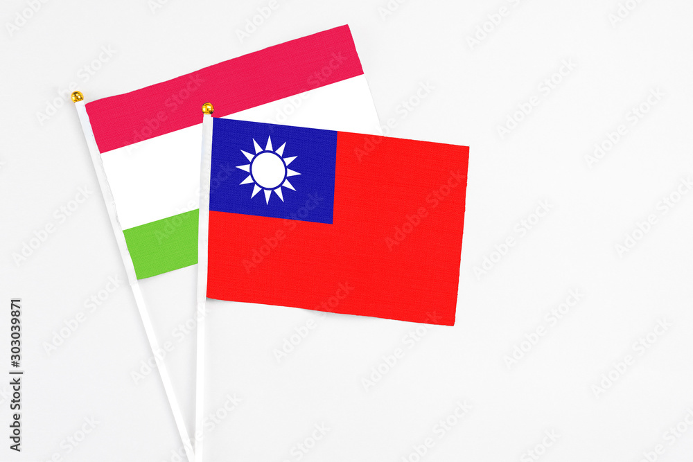 Taiwan and Tajikistan stick flags on white background. High quality fabric, miniature national flag. Peaceful global concept.White floor for copy space.