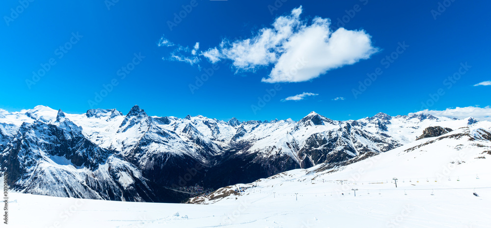 Caucasus mountains - The highest mountains in Russia. Snow mountains with blue sky background. Panorama