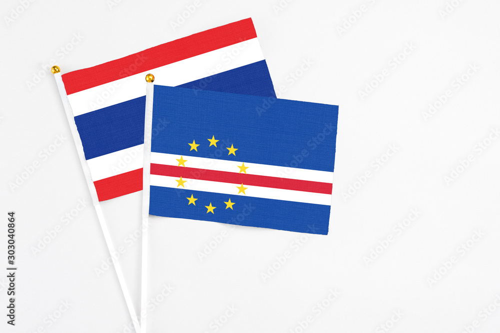 Cape Verde and Thailand stick flags on white background. High quality fabric, miniature national flag. Peaceful global concept.White floor for copy space. Cape Verde and Thailand stick flags on white background. High quality fabric, miniature national flag. Peaceful global concept.White floor for copy space.