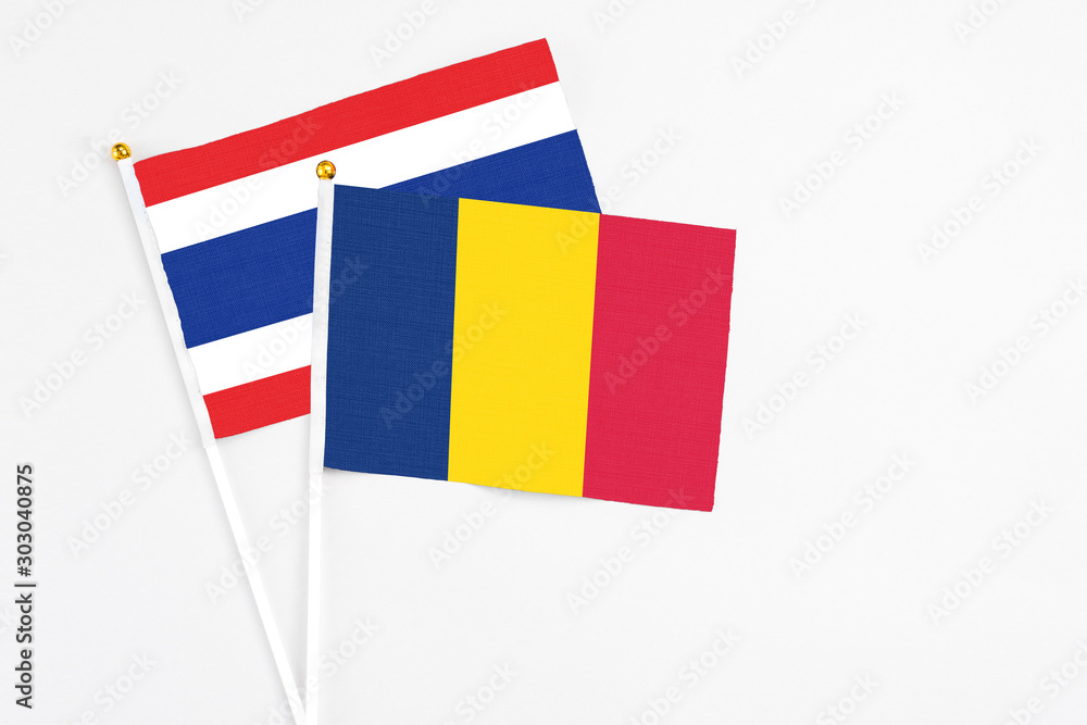 Chad and Thailand stick flags on white background. High quality fabric, miniature national flag. Peaceful global concept.White floor for copy space. Chad and Thailand stick flags on white background. High quality fabric, miniature national flag. Peaceful global concept.White floor for copy space.