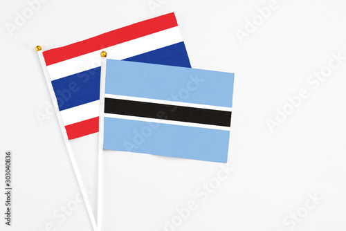 Free Download Botswana and Thailand stick flags on white background. High quality fabric, miniature national flag. Peaceful global concept.White floor for copy space. - GFXLoad