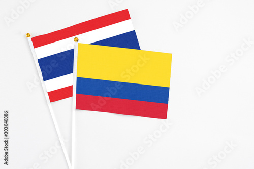 Free Download Colombia and Thailand stick flags on white background. High quality fabric, miniature national flag. Peaceful global concept.White floor for copy space. - GFXLoad