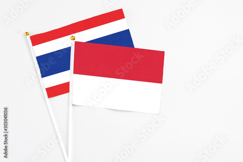 Free Download Indonesia and Thailand stick flags on white background. High quality fabric, miniature national flag. Peaceful global concept.White floor for copy space. - GFXLoad