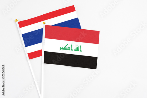 Free Download Iraq and Thailand stick flags on white background. High quality fabric, miniature national flag. Peaceful global concept.White floor for copy space. - GFXLoad