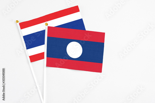 Free Download Laos and Thailand stick flags on white background. High quality fabric, miniature national flag. Peaceful global concept.White floor for copy space. - GFXLoad