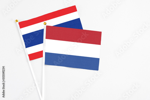 Netherlands and Thailand stick flags on white background. High quality fabric, miniature national flag. Peaceful global concept.White floor for copy space. Free Download Netherlands and Thailand stick flags on white background. High quality fabric, miniature national flag. Peaceful global concept.White floor for copy space. - GFXLoad