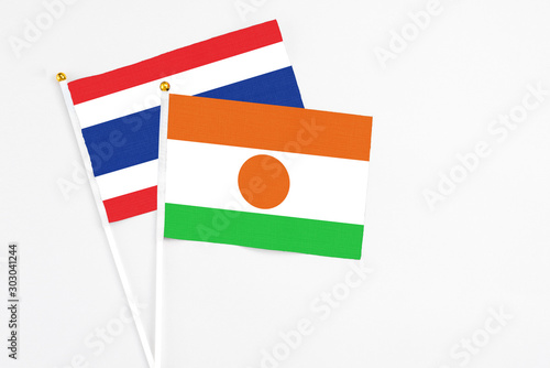 Free Download Niger and Thailand stick flags on white background. High quality fabric, miniature national flag. Peaceful global concept.White floor for copy space. - GFXLoad
