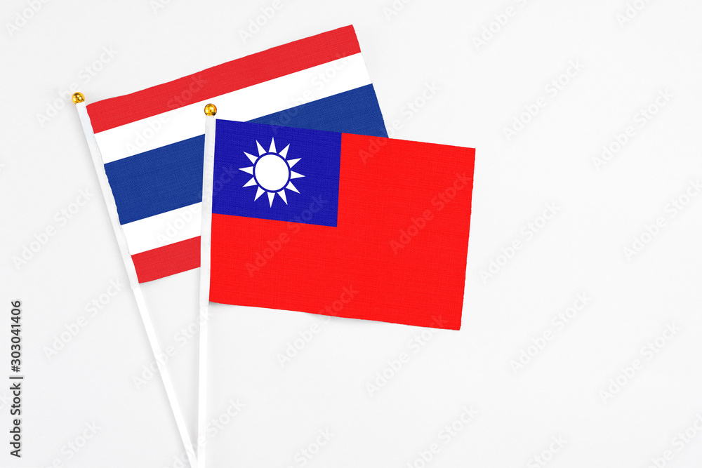 Taiwan and Thailand stick flags on white background. High quality fabric, miniature national flag. Peaceful global concept.White floor for copy space.