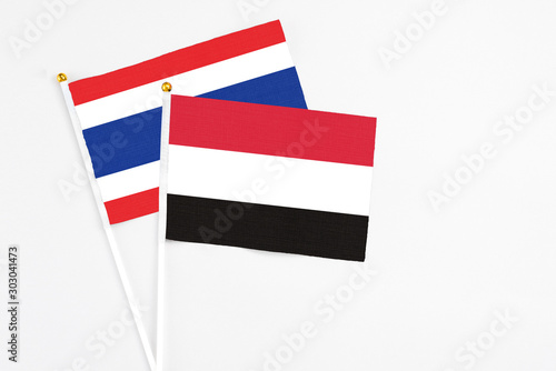 Free Download Yemen and Thailand stick flags on white background. High quality fabric, miniature national flag. Peaceful global concept.White floor for copy space. - GFXLoad