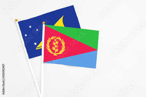 Free Download Eritrea and Tokelau stick flags on white background. High quality fabric, miniature national flag. Peaceful global concept.White floor for copy space. - GFXLoad