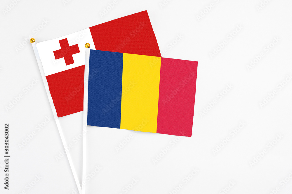 Chad and Tonga stick flags on white background. High quality fabric, miniature national flag. Peaceful global concept.White floor for copy space. Chad and Tonga stick flags on white background. High quality fabric, miniature national flag. Peaceful global concept.White floor for copy space.