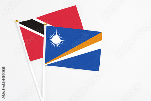 Free Download Marshall Islands and Trinidad And Tobago stick flags on white background. High quality fabric, miniature national flag. Peaceful global concept.White floor for copy space. - GFXLoad