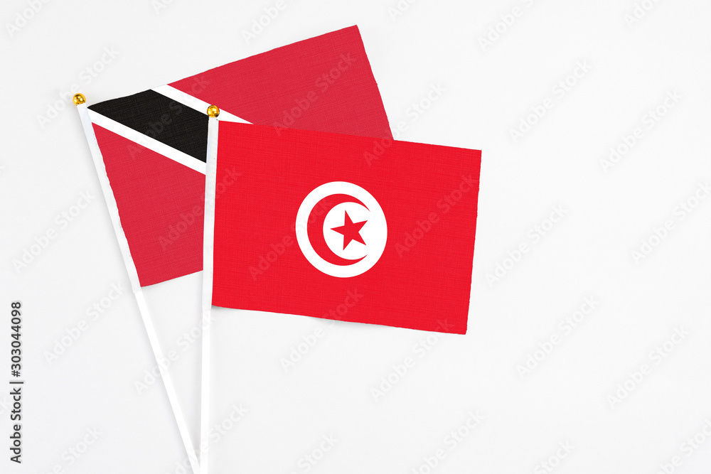Tunisia and Trinidad And Tobago stick flags on white background. High quality fabric, miniature national flag. Peaceful global concept.White floor for copy space. Tunisia and Trinidad And Tobago stick flags on white background. High quality fabric, miniature national flag. Peaceful global concept.White floor for copy space.