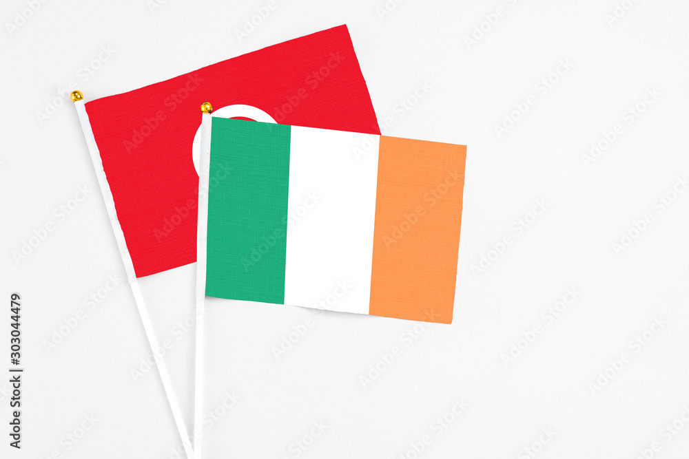 Ireland and Tunisia stick flags on white background. High quality fabric, miniature national flag. Peaceful global concept.White floor for copy space. Ireland and Tunisia stick flags on white background. High quality fabric, miniature national flag. Peaceful global concept.White floor for copy space.