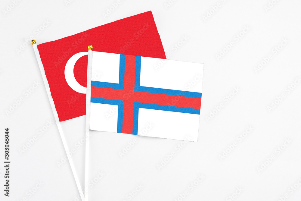 Faroe Islands and Turkey stick flags on white background. High quality fabric, miniature national flag. Peaceful global concept.White floor for copy space.