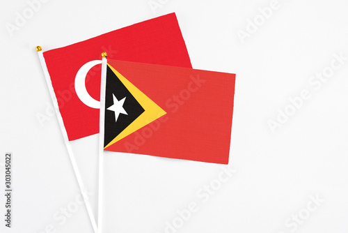 Free Download East Timor and Turkey stick flags on white background. High quality fabric, miniature national flag. Peaceful global concept.White floor for copy space. - GFXLoad