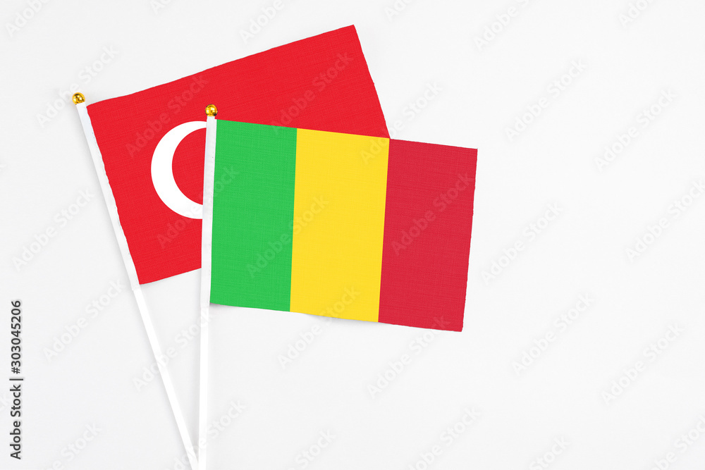 Mali and Turkey stick flags on white background. High quality fabric, miniature national flag. Peaceful global concept.White floor for copy space. Mali and Turkey stick flags on white background. High quality fabric, miniature national flag. Peaceful global concept.White floor for copy space.