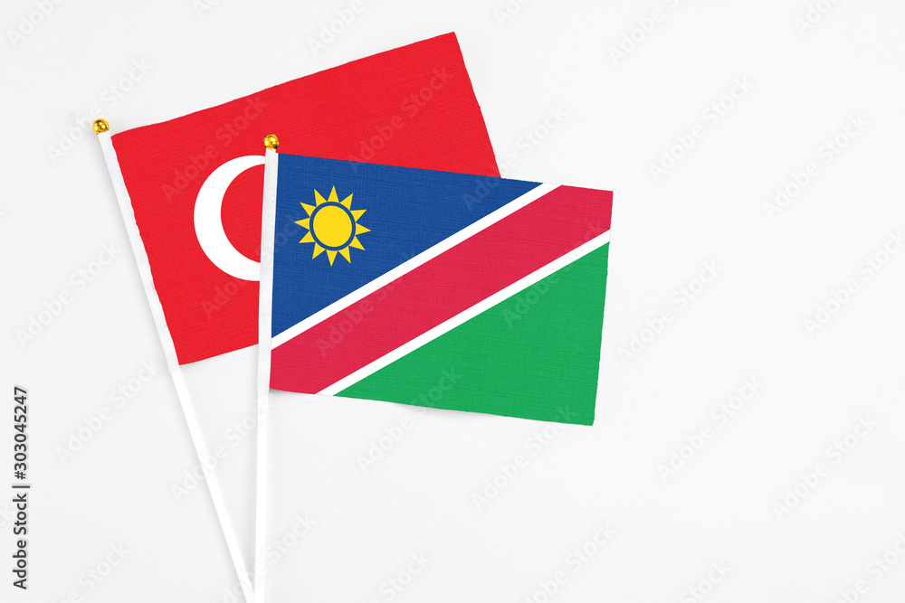 Namibia and Turkey stick flags on white background. High quality fabric, miniature national flag. Peaceful global concept.White floor for copy space. Namibia and Turkey stick flags on white background. High quality fabric, miniature national flag. Peaceful global concept.White floor for copy space.