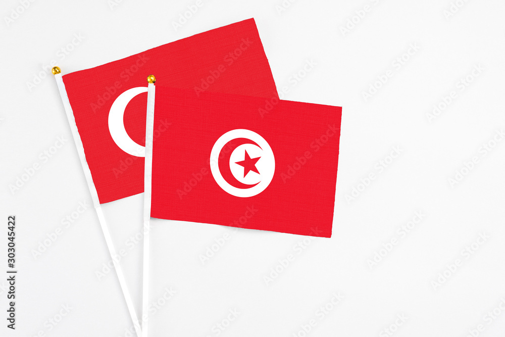 Tunisia and Turkey stick flags on white background. High quality fabric, miniature national flag. Peaceful global concept.White floor for copy space. Tunisia and Turkey stick flags on white background. High quality fabric, miniature national flag. Peaceful global concept.White floor for copy space.