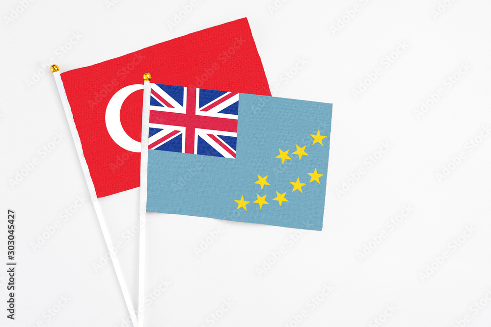 Tuvalu and Turkey stick flags on white background. High quality fabric, miniature national flag. Peaceful global concept.White floor for copy space. Tuvalu and Turkey stick flags on white background. High quality fabric, miniature national flag. Peaceful global concept.White floor for copy space.