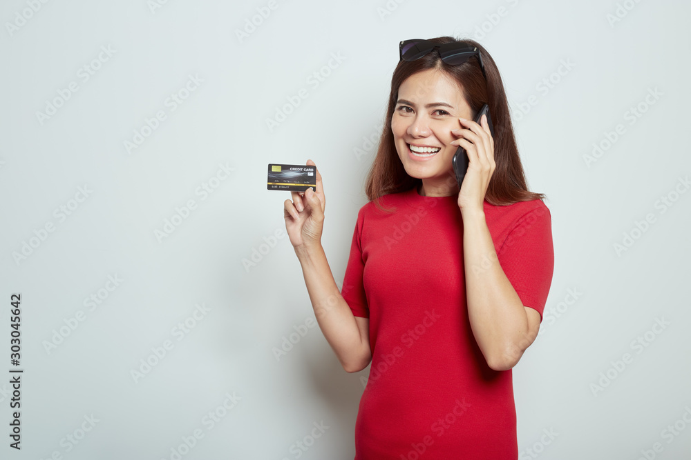 Woman using a mobile phone with credit card Woman using a mobile phone with credit card