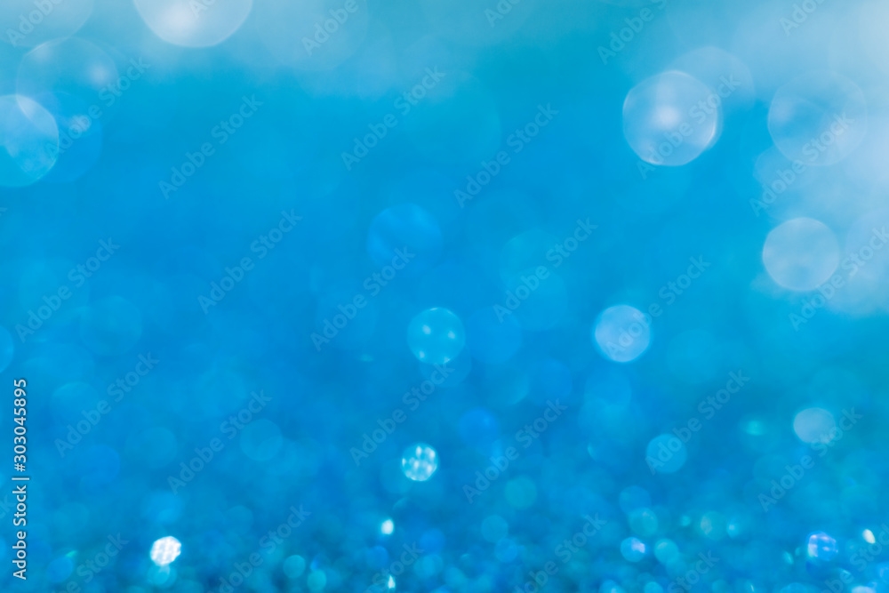 Blue sparkle glitter from diamond dust falling on the floor, blue sea water with sunlight fall over with foam. Have a lot of bokeh