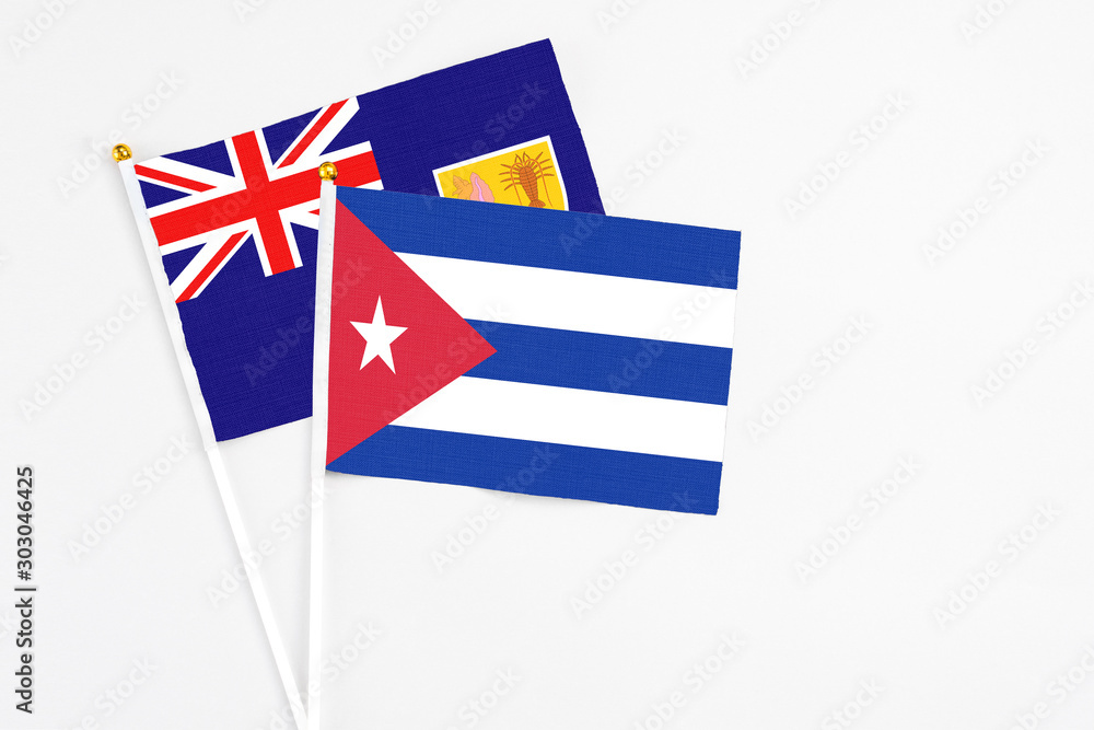Cuba and Turks And Caicos Islands stick flags on white background. High quality fabric, miniature national flag. Peaceful global concept.White floor for copy space. Cuba and Turks And Caicos Islands stick flags on white background. High quality fabric, miniature national flag. Peaceful global concept.White floor for copy space.