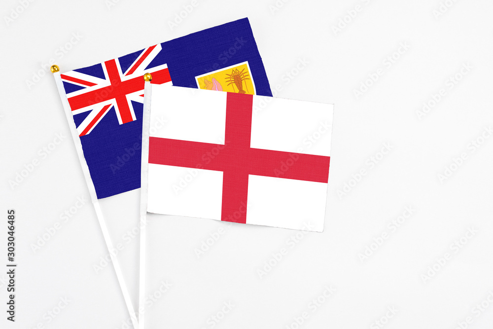 England and Turks And Caicos Islands stick flags on white background. High quality fabric, miniature national flag. Peaceful global concept.White floor for copy space.