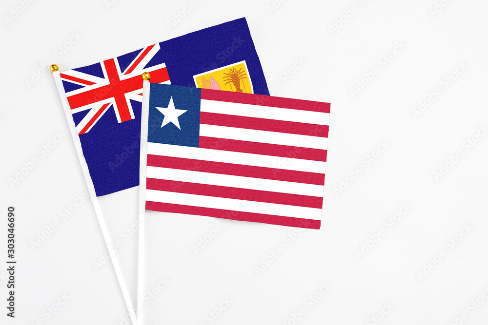 Liberia and Turks And Caicos Islands stick flags on white background. High quality fabric, miniature national flag. Peaceful global concept.White floor for copy space. Liberia and Turks And Caicos Islands stick flags on white background. High quality fabric, miniature national flag. Peaceful global concept.White floor for copy space.