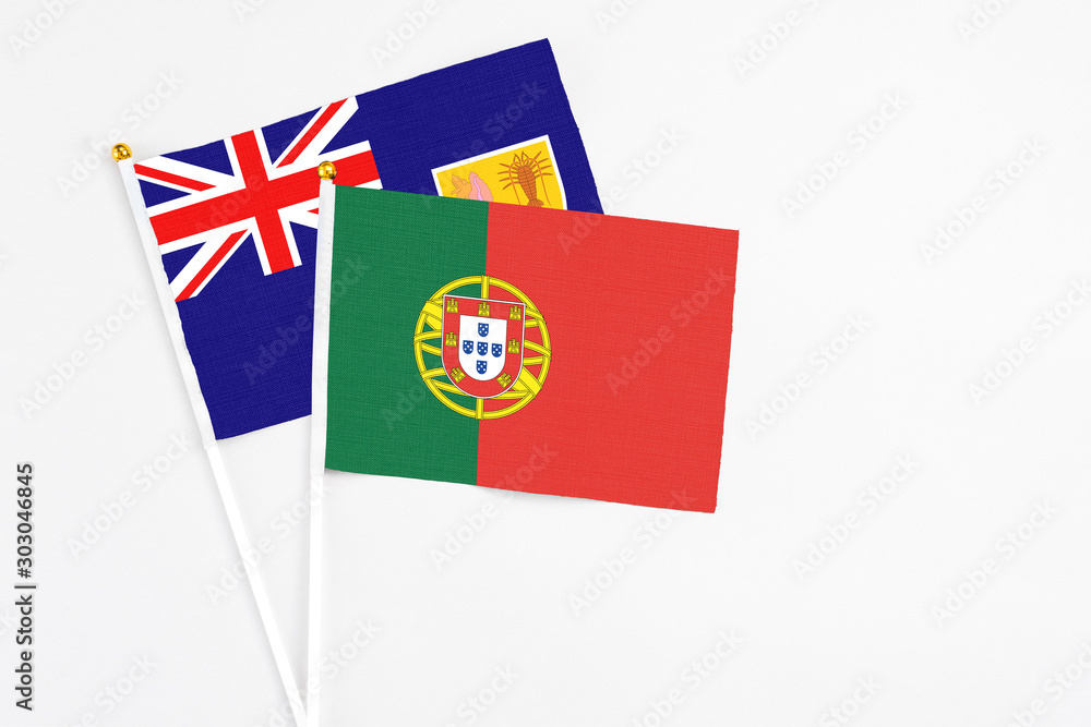 Portugal and Turks And Caicos Islands stick flags on white background. High quality fabric, miniature national flag. Peaceful global concept.White floor for copy space. Portugal and Turks And Caicos Islands stick flags on white background. High quality fabric, miniature national flag. Peaceful global concept.White floor for copy space.
