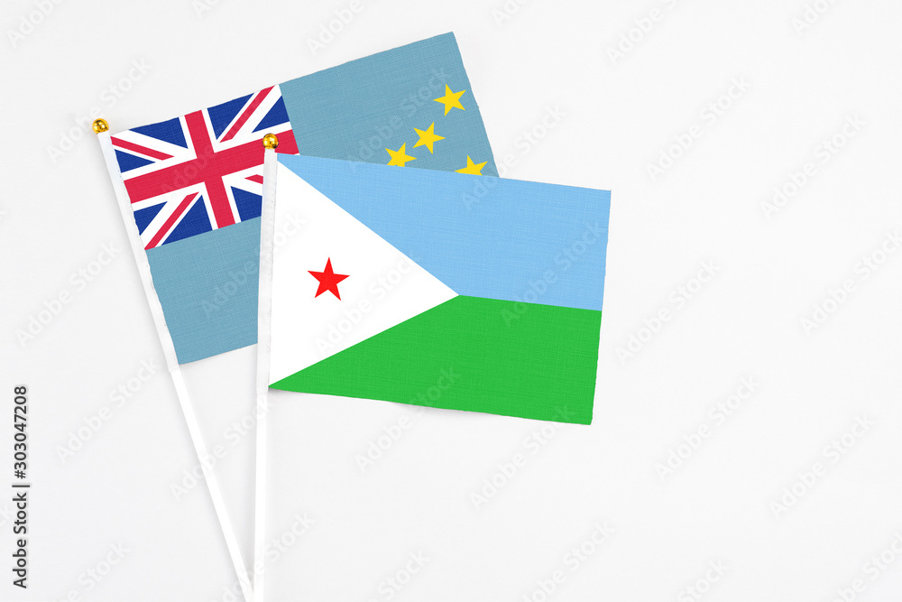 Djibouti and Tuvalu stick flags on white background. High quality fabric, miniature national flag. Peaceful global concept.White floor for copy space. Djibouti and Tuvalu stick flags on white background. High quality fabric, miniature national flag. Peaceful global concept.White floor for copy space.