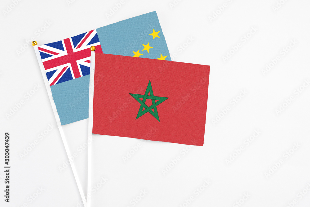 Morocco and Tuvalu stick flags on white background. High quality fabric, miniature national flag. Peaceful global concept.White floor for copy space. Morocco and Tuvalu stick flags on white background. High quality fabric, miniature national flag. Peaceful global concept.White floor for copy space.
