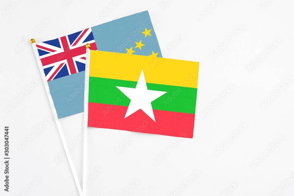 Fototapeta premium Myanmar and Tuvalu stick flags on white background. High quality fabric, miniature national flag. Peaceful global concept.White floor for copy space.