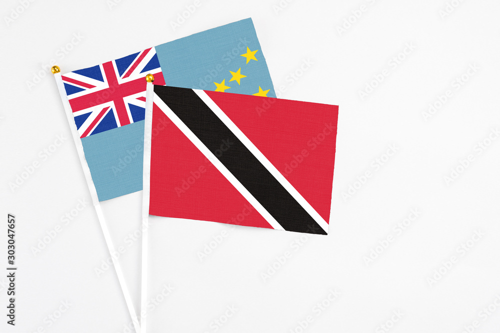 Trinidad And Tobago and Tuvalu stick flags on white background. High quality fabric, miniature national flag. Peaceful global concept.White floor for copy space. Trinidad And Tobago and Tuvalu stick flags on white background. High quality fabric, miniature national flag. Peaceful global concept.White floor for copy space.
