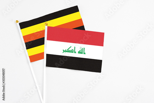 Free Download Iraq and Uganda stick flags on white background. High quality fabric, miniature national flag. Peaceful global concept.White floor for copy space. - GFXLoad