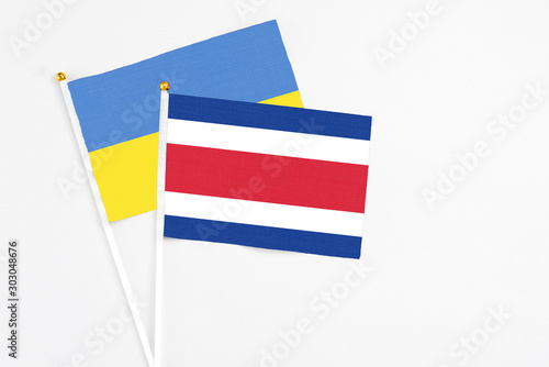 Free Download Costa Rica and Ukraine stick flags on white background. High quality fabric, miniature national flag. Peaceful global concept.White floor for copy space. - GFXLoad