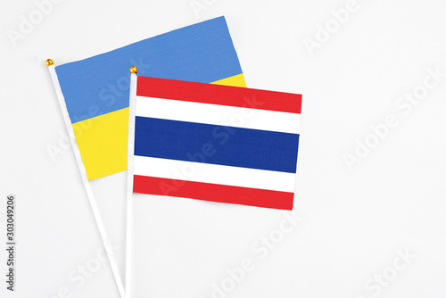 Free Download Thailand and Ukraine stick flags on white background. High quality fabric, miniature national flag. Peaceful global concept.White floor for copy space. - GFXLoad