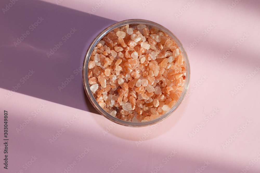 Himalayan salt. Bath salt. Spa treatment. The industry of beauty and relaxation. Scattered salt on a white background. Bath of crystals in a transparent jar. The view from the top. Space for text. Himalayan salt. Bath salt. Spa treatment. The industry of beauty and relaxation. Scattered salt on a white background. Bath of crystals in a transparent jar. The view from the top. Space for text.