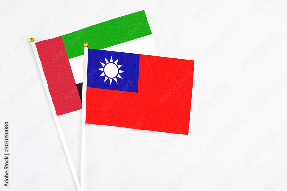 Taiwan and United Arab Emirates stick flags on white background. High quality fabric, miniature national flag. Peaceful global concept.White floor for copy space. Taiwan and United Arab Emirates stick flags on white background. High quality fabric, miniature national flag. Peaceful global concept.White floor for copy space.