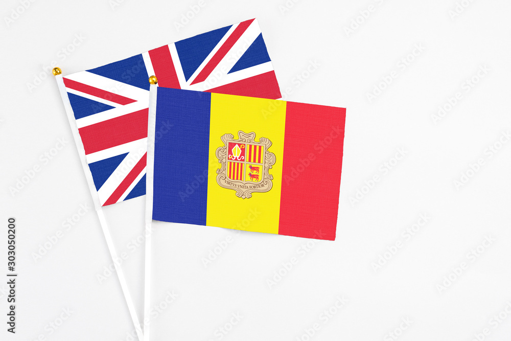Andorra and United Kingdom stick flags on white background. High quality fabric, miniature national flag. Peaceful global concept.White floor for copy space. Andorra and United Kingdom stick flags on white background. High quality fabric, miniature national flag. Peaceful global concept.White floor for copy space.
