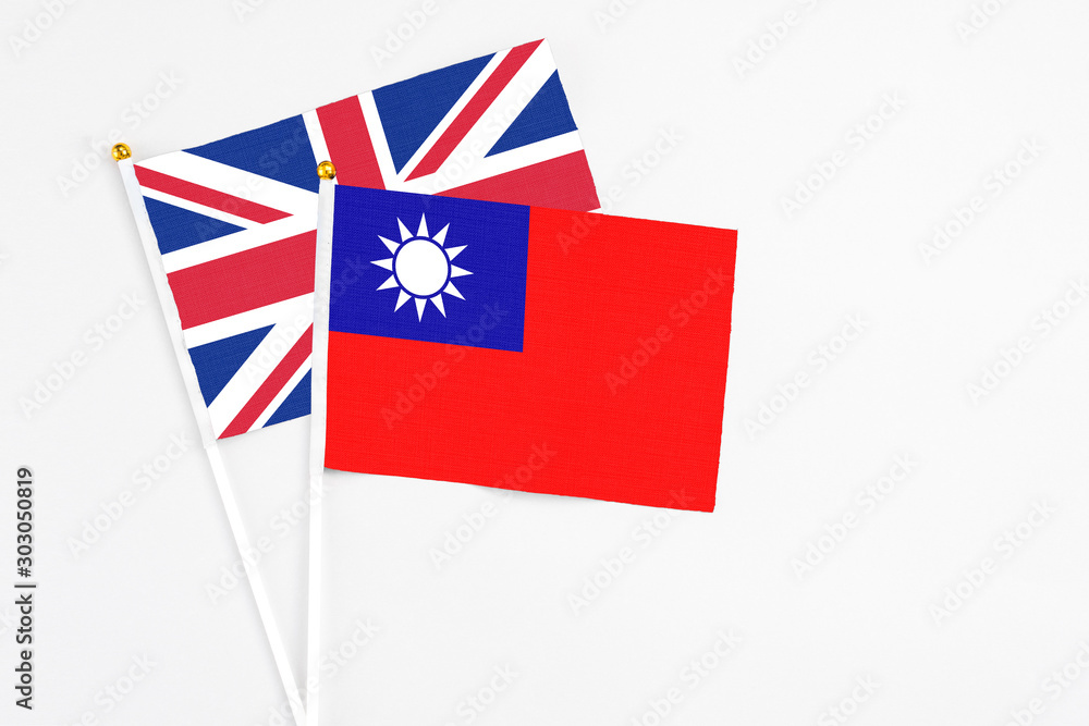 Taiwan and United Kingdom stick flags on white background. High quality fabric, miniature national flag. Peaceful global concept.White floor for copy space. Taiwan and United Kingdom stick flags on white background. High quality fabric, miniature national flag. Peaceful global concept.White floor for copy space.