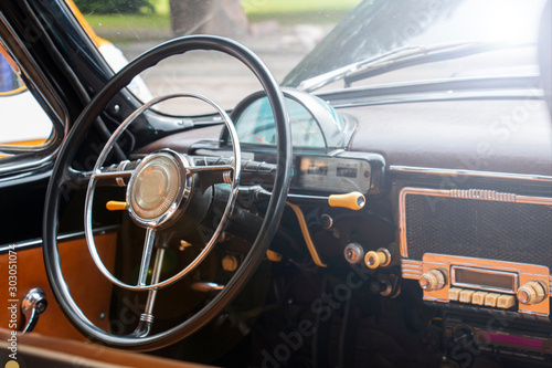 Vintage retro car interior. Old car steering wheel. Vintage retro car interior