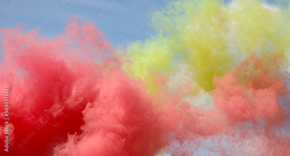 Red and yellow smoke on a blue sky Red and yellow smoke on a blue sky