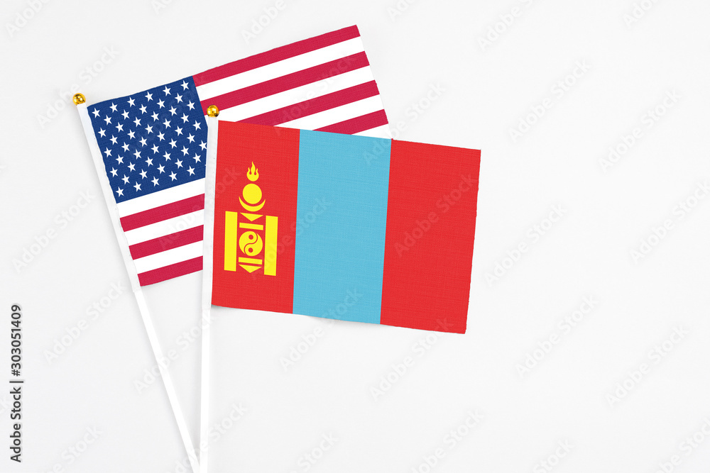 Obraz premium Mongolia and United States stick flags on white background. High quality fabric, miniature national flag. Peaceful global concept.White floor for copy space.