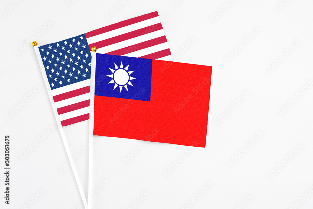 Taiwan and United States stick flags on white background. High quality fabric, miniature national flag. Peaceful global concept.White floor for copy space. Taiwan and United States stick flags on white background. High quality fabric, miniature national flag. Peaceful global concept.White floor for copy space.