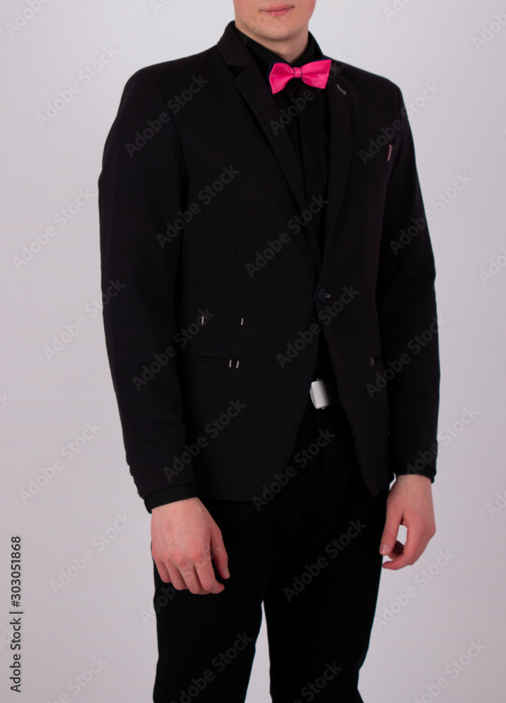 Young Guy In A Black Suit With A Pink Bow Tie Stock Photo | Adobe Stock