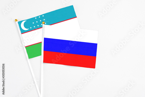 Photography Russia and Uzbekistan stick flags on white background