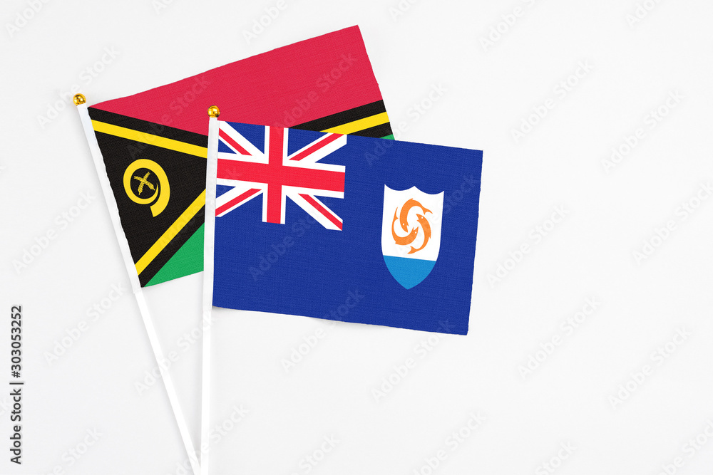 Fototapeta premium Anguilla and Vanuatu stick flags on white background. High quality fabric, miniature national flag. Peaceful global concept.White floor for copy space.