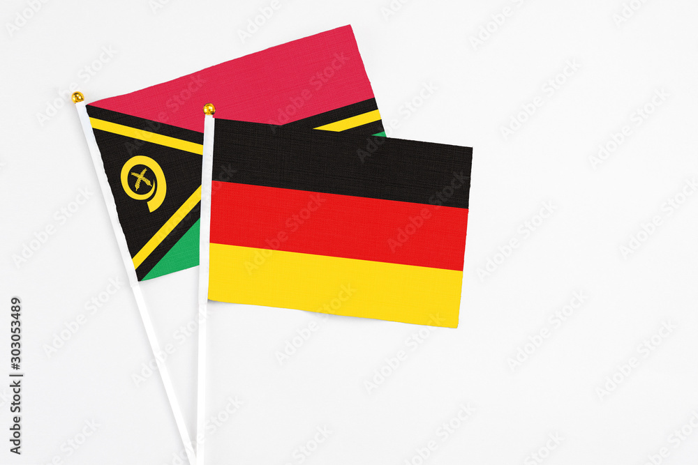 Germany and Vanuatu stick flags on white background. High quality fabric, miniature national flag. Peaceful global concept.White floor for copy space. Germany and Vanuatu stick flags on white background. High quality fabric, miniature national flag. Peaceful global concept.White floor for copy space.