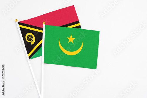 Mauritania and Vanuatu stick flags on white background. High quality fabric, miniature national flag. Peaceful global concept.White floor for copy space.